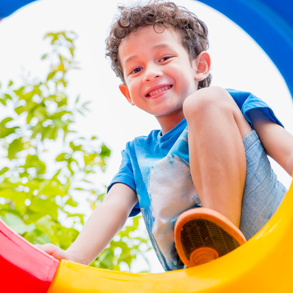 kid boy having fun to play on children's climbing toy at school playgroundback to school activity